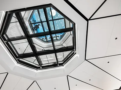 View from beneath clear glass floor showing viewer from above looking down.