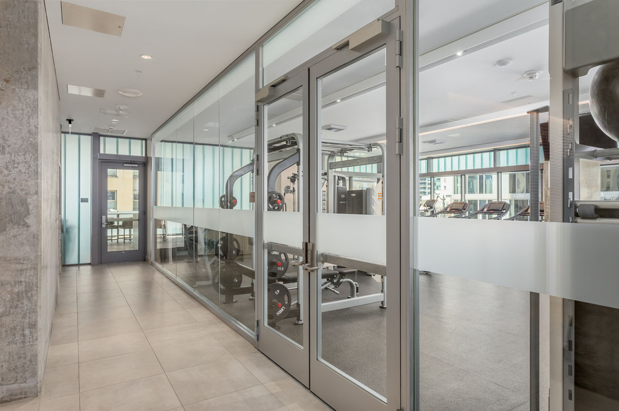 Fire-rated full lite door system in the hallway of a high rise apartment building. 